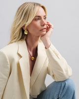 Discover the  Brioche Earrings by MÉGA Jewelry—oversized, sculptural hoops available in 14k gold or sterling silver vermeil. A bold statement piece for any jewelry collection.