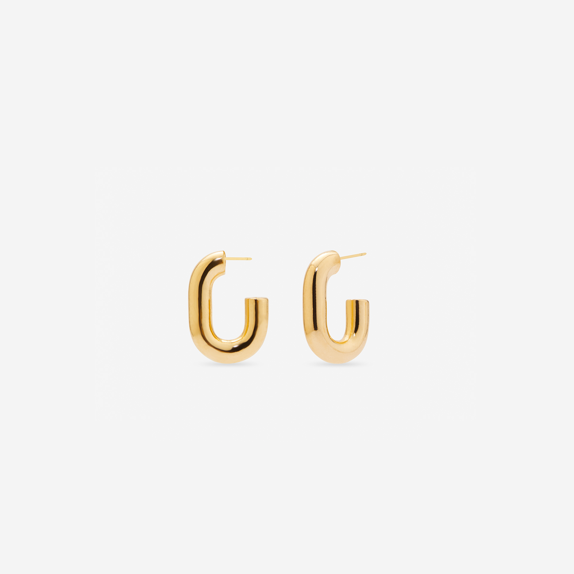 MÉGA Half Paper Clip Earrings in gold vermeil—16 mm long, 3.5 mm wide sculptural oval hoops with stainless-steel posts, 5.54 g.