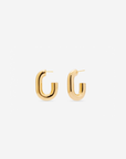 MÉGA Half Paper Clip Earrings in gold vermeil—16 mm long, 3.5 mm wide sculptural oval hoops with stainless-steel posts, 5.54 g.