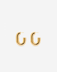 MÉGA Half Paper Clip Earrings in gold vermeil—16 mm long, 3.5 mm wide sculptural oval hoops with stainless-steel posts, 5.54 g.