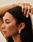 MÉGA Dalmatian Earrings in gold vermeil—sculptural studs with scattered CZ accents, stainless-steel posts, lightweight and refined.