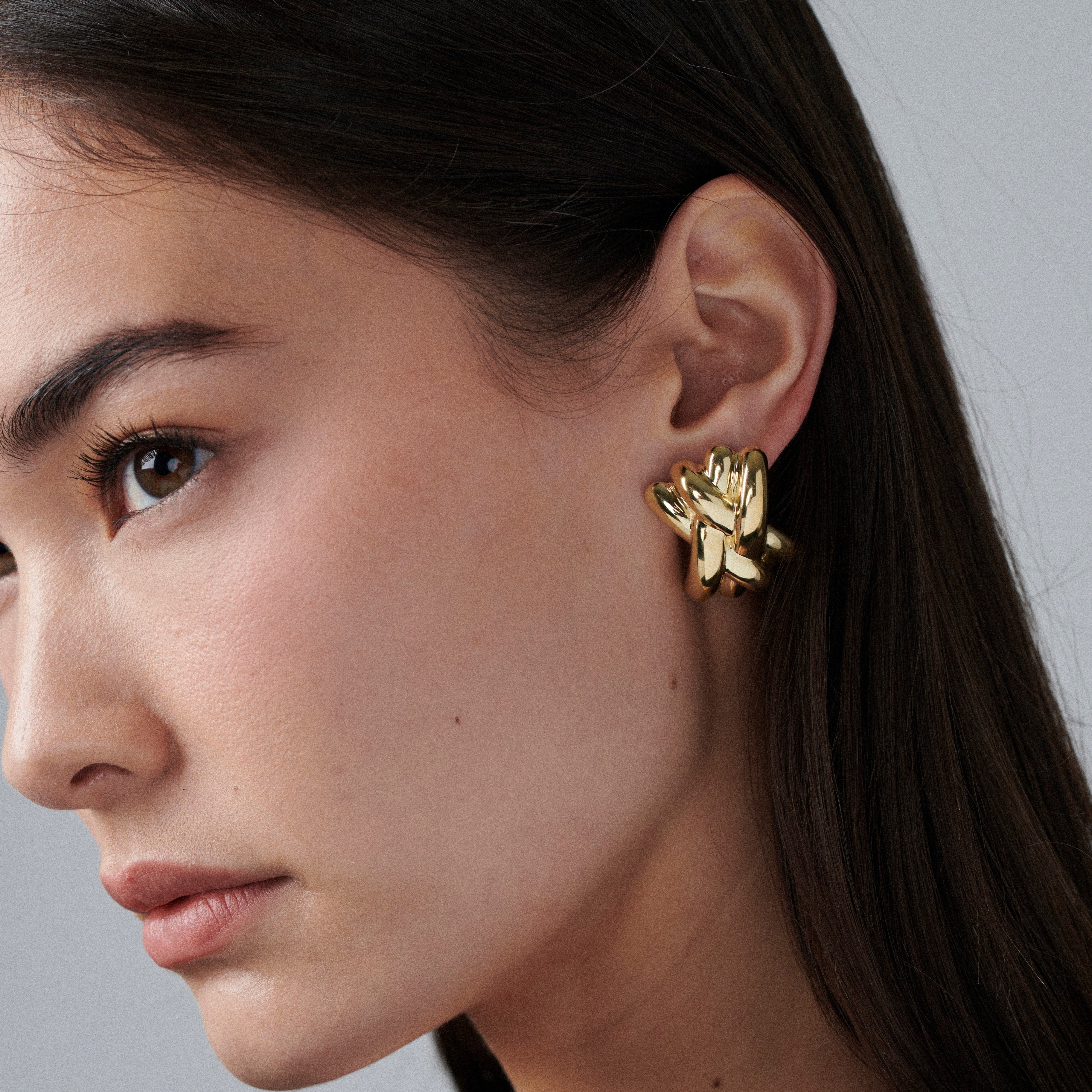 Pair of gold vermeil lattice earrings with interwoven sculptural design, displayed on a white background
