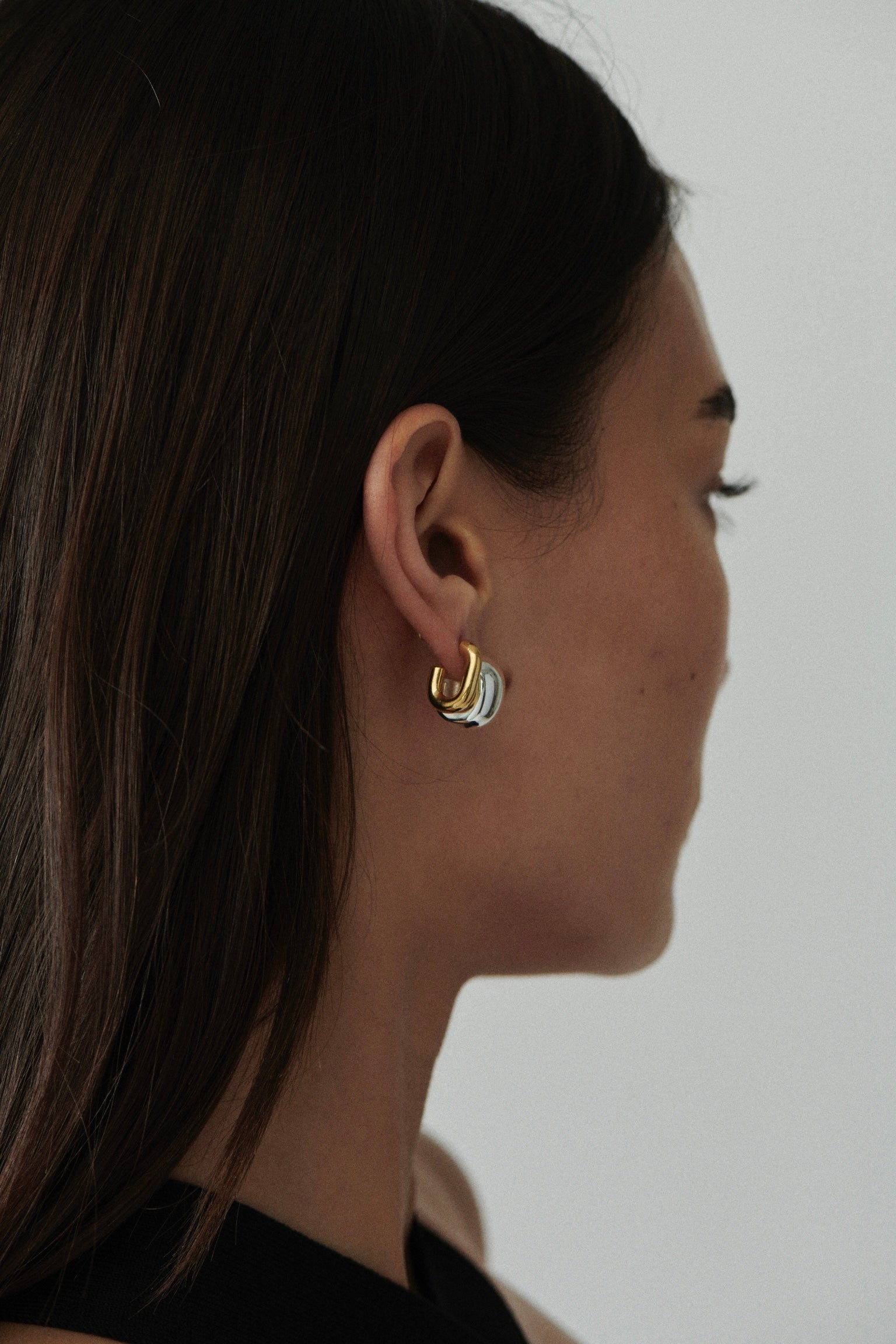 MÉGA Half Paper Clip Earrings in gold vermeil—16 mm long, 3.5 mm wide sculptural oval hoops with stainless-steel posts, 5.54 g.