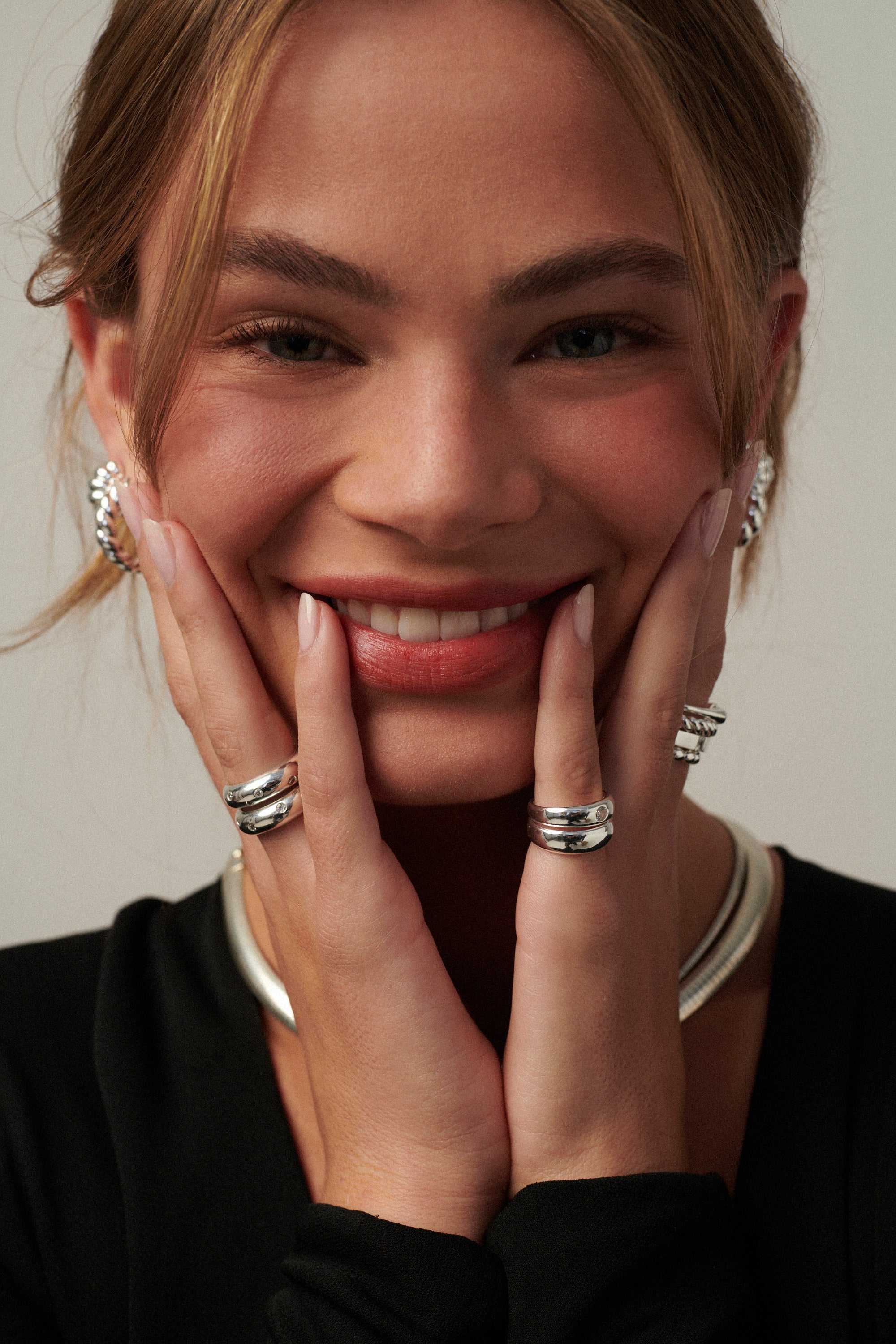Two interlocking gold vermeil sterling silver pinky rings—one plain band and one set with a 3.5mm CZ, styled together