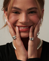 Two interlocking gold vermeil sterling silver pinky rings—one plain band and one set with a 3.5mm CZ, styled together