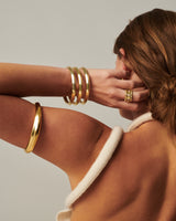 MÉGA Bicep Bangle in gold vermeil—tapered brass upper‑arm cuff, 10.5 mm to 15.6 mm wide, 61.7 g.