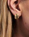 MÉGA Mini Oval Ridged Button Earrings in gold with sculptural ridged texture, 16.8 mm x 14.5 mm.
