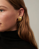 Double-hoop earrings with a sculptural silhouette, crafted in brass with 14k gold vermeil or 925 sterling silver vermeil—lightweight and bold.