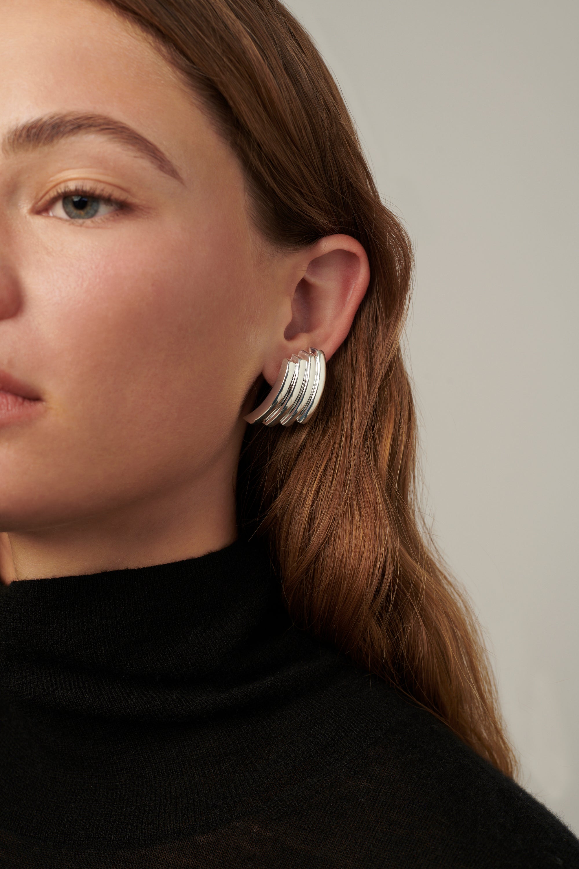 Double-hoop earrings with a sculptural silhouette, crafted in brass with 14k gold vermeil or 925 sterling silver vermeil—lightweight and bold.