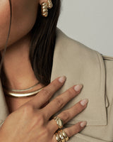 Two interlocking gold vermeil sterling silver pinky rings—one plain band and one set with a 3.5mm CZ, styled together