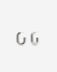MÉGA Half Paper Clip Earrings in gold vermeil—16 mm long, 3.5 mm wide sculptural oval hoops with stainless-steel posts, 5.54 g.