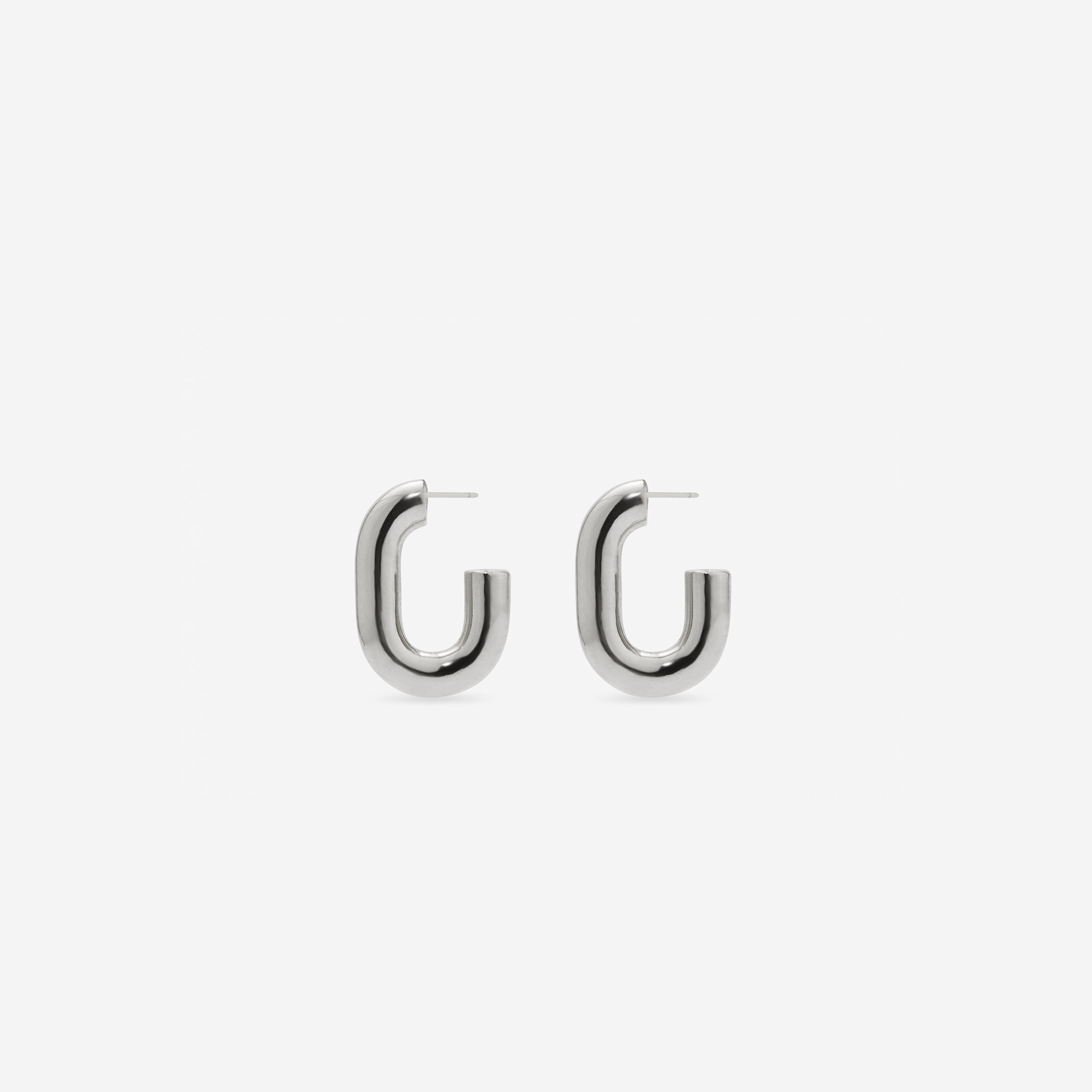 MÉGA Half Paper Clip Earrings in gold vermeil—16 mm long, 3.5 mm wide sculptural oval hoops with stainless-steel posts, 5.54 g.