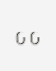 MÉGA Half Paper Clip Earrings in gold vermeil—16 mm long, 3.5 mm wide sculptural oval hoops with stainless-steel posts, 5.54 g.