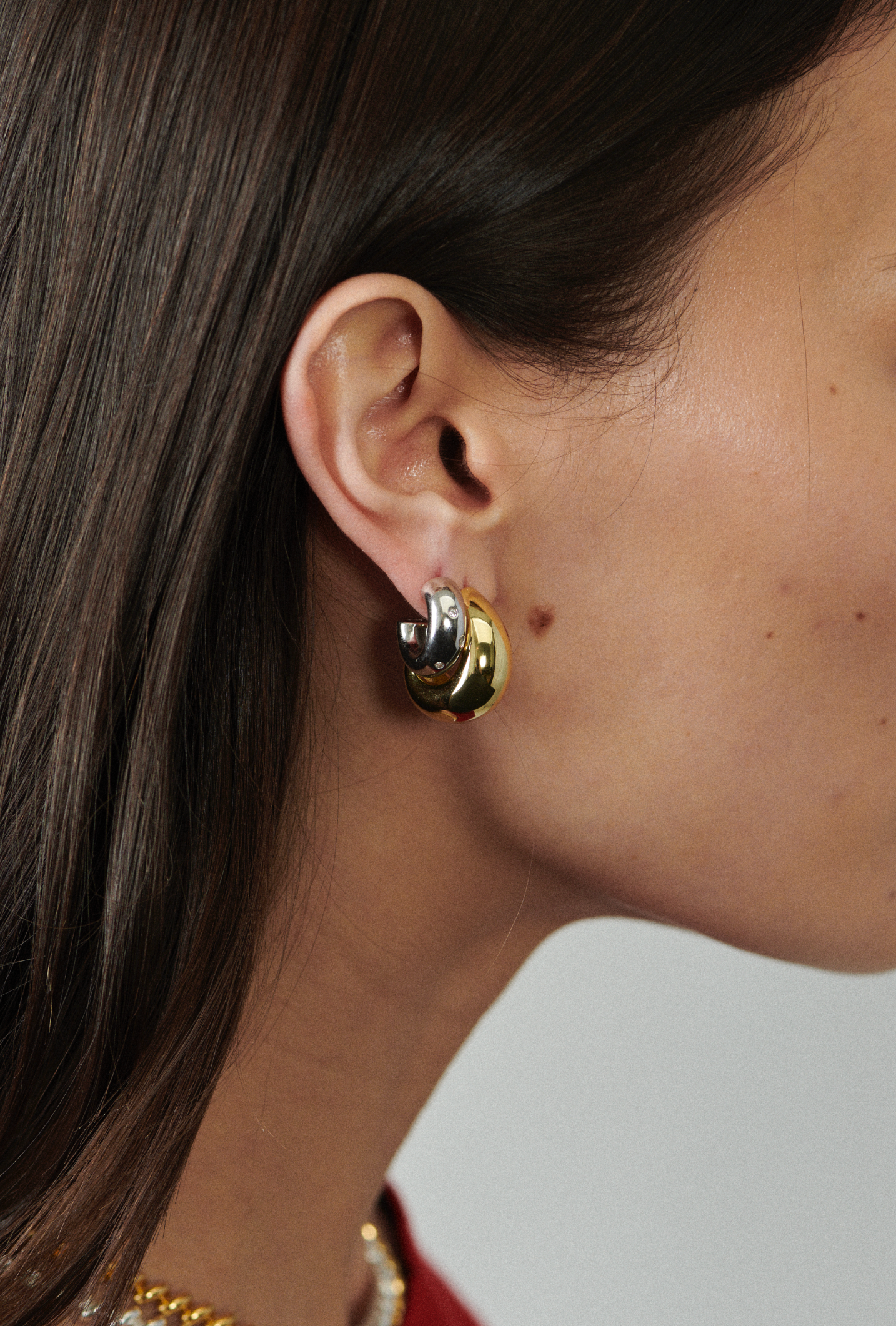MÉGA Dalmatian Earrings in gold vermeil—sculptural studs with scattered CZ accents, stainless-steel posts, lightweight and refined.
