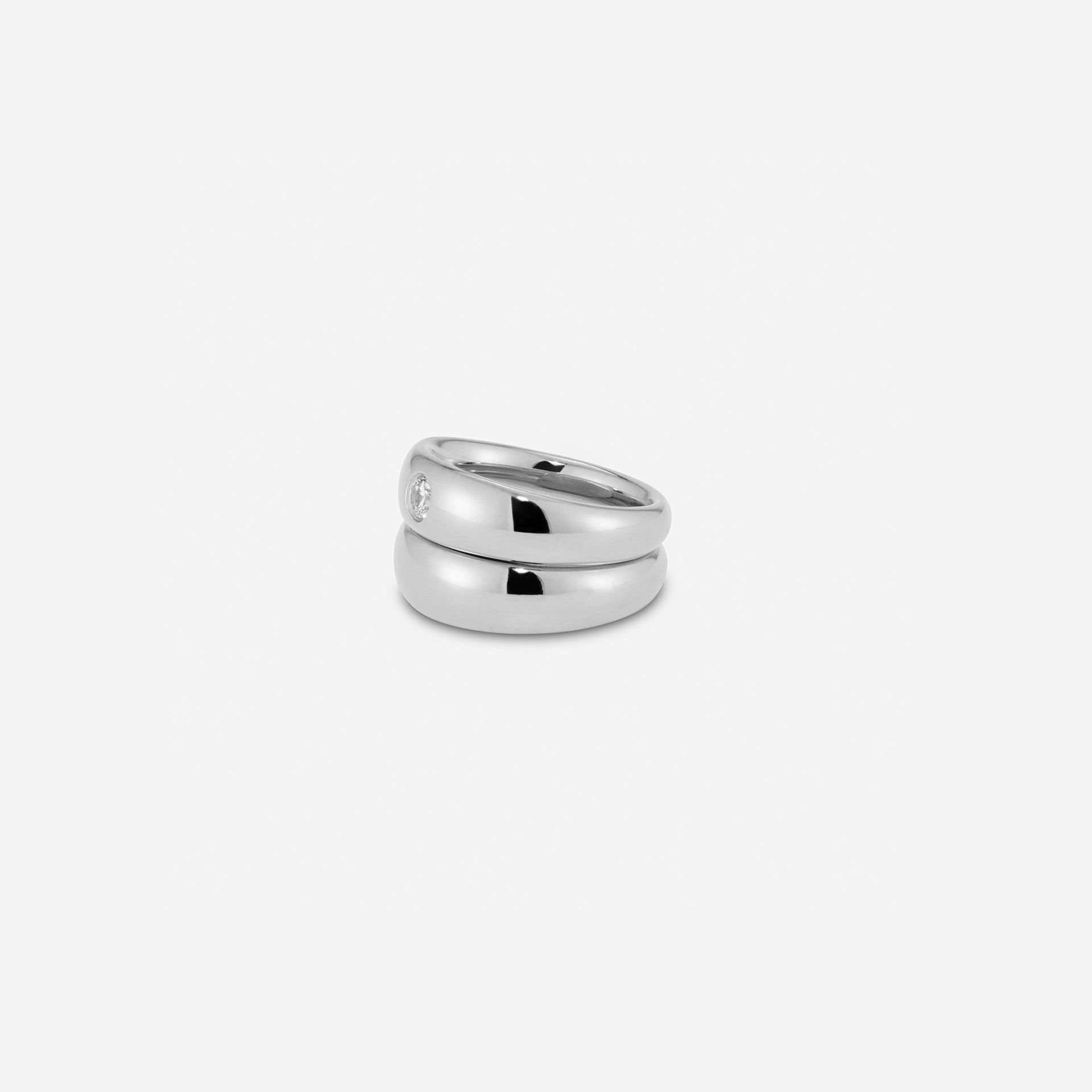 Two interlocking gold vermeil sterling silver pinky rings—one plain band and one set with a 3.5mm CZ, styled together