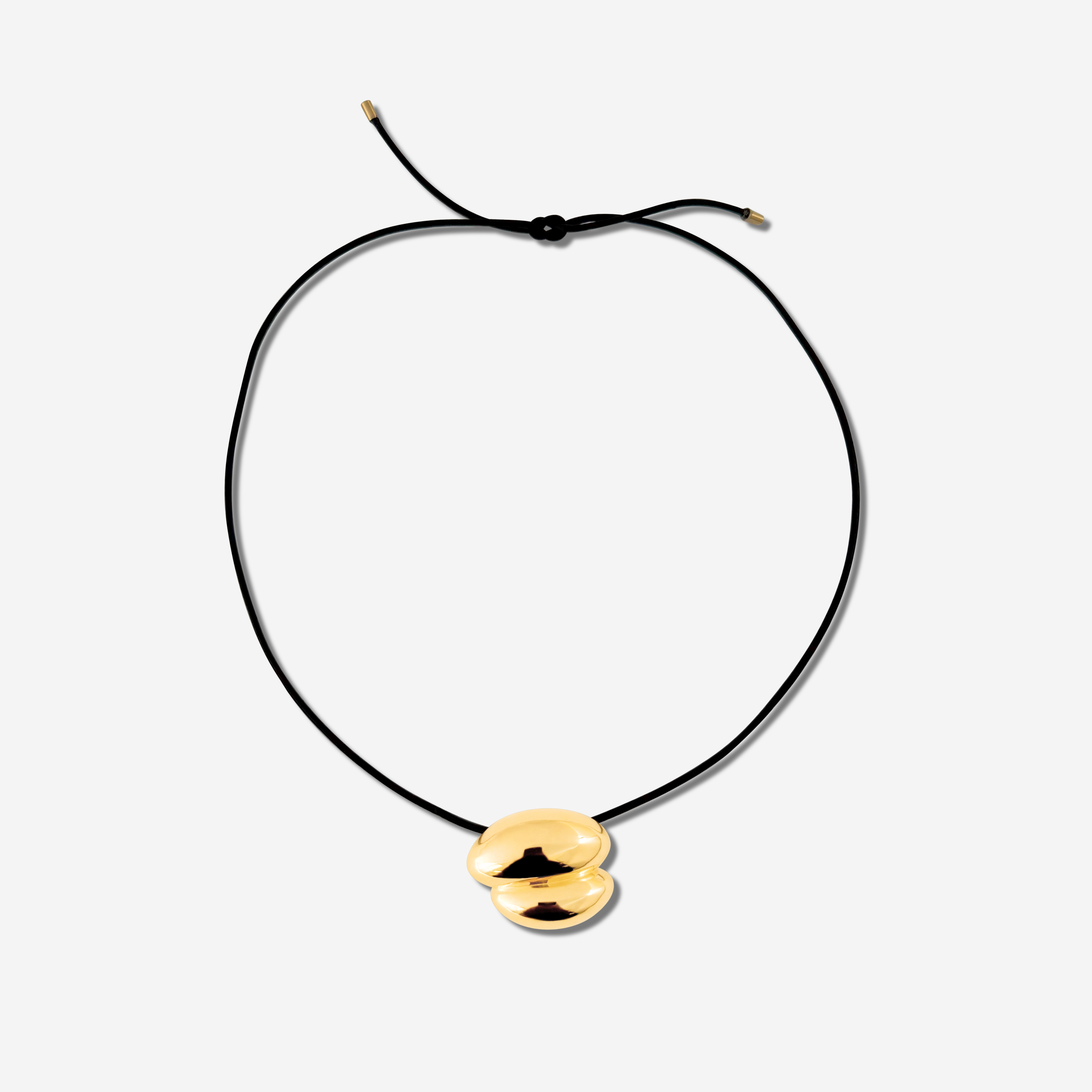 Featuring a sculptural pendant on an adjustable black leather cord, available in 14k gold or sterling silver vermeil.
