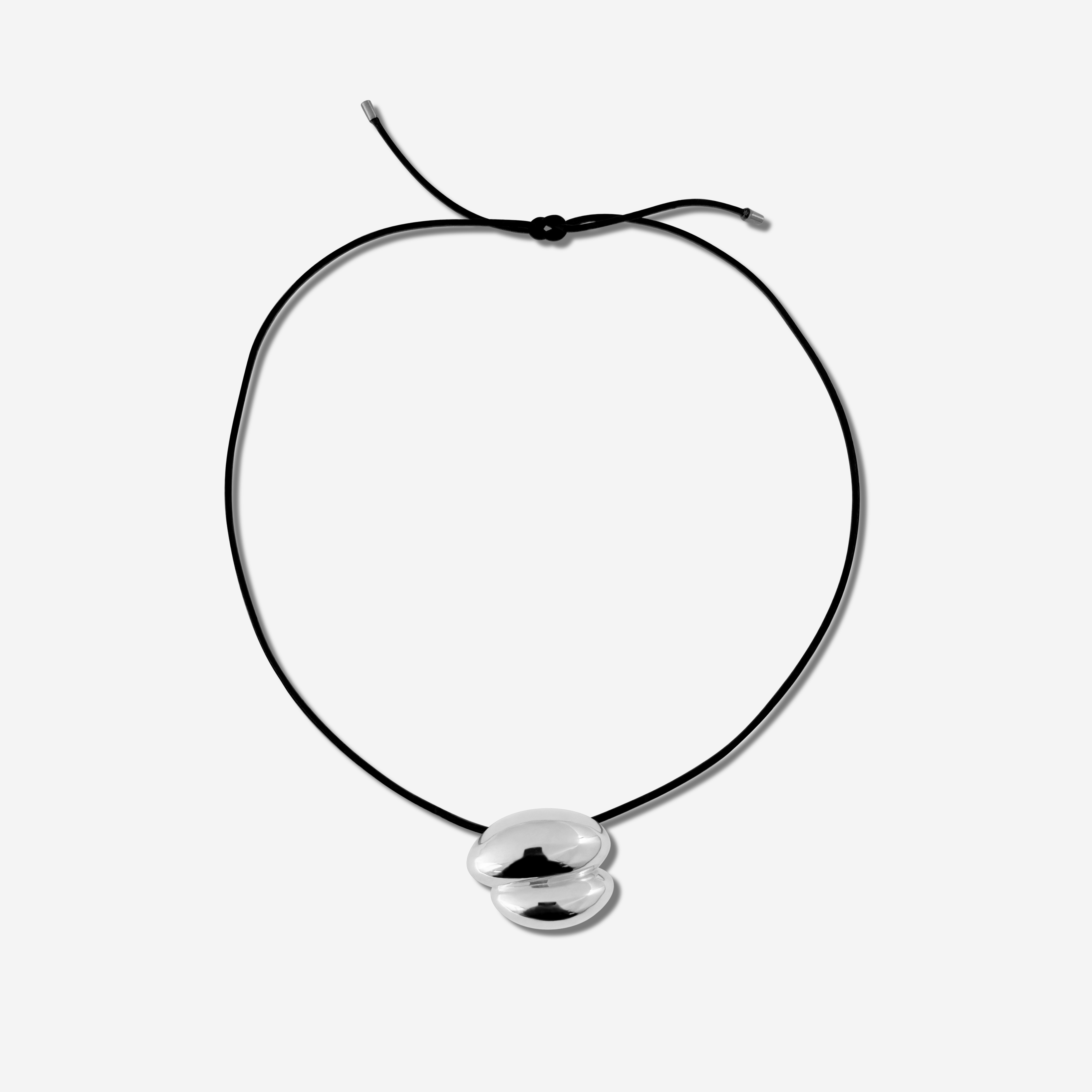 Featuring a sculptural pendant on an adjustable black leather cord, available in 14k gold or sterling silver vermeil.