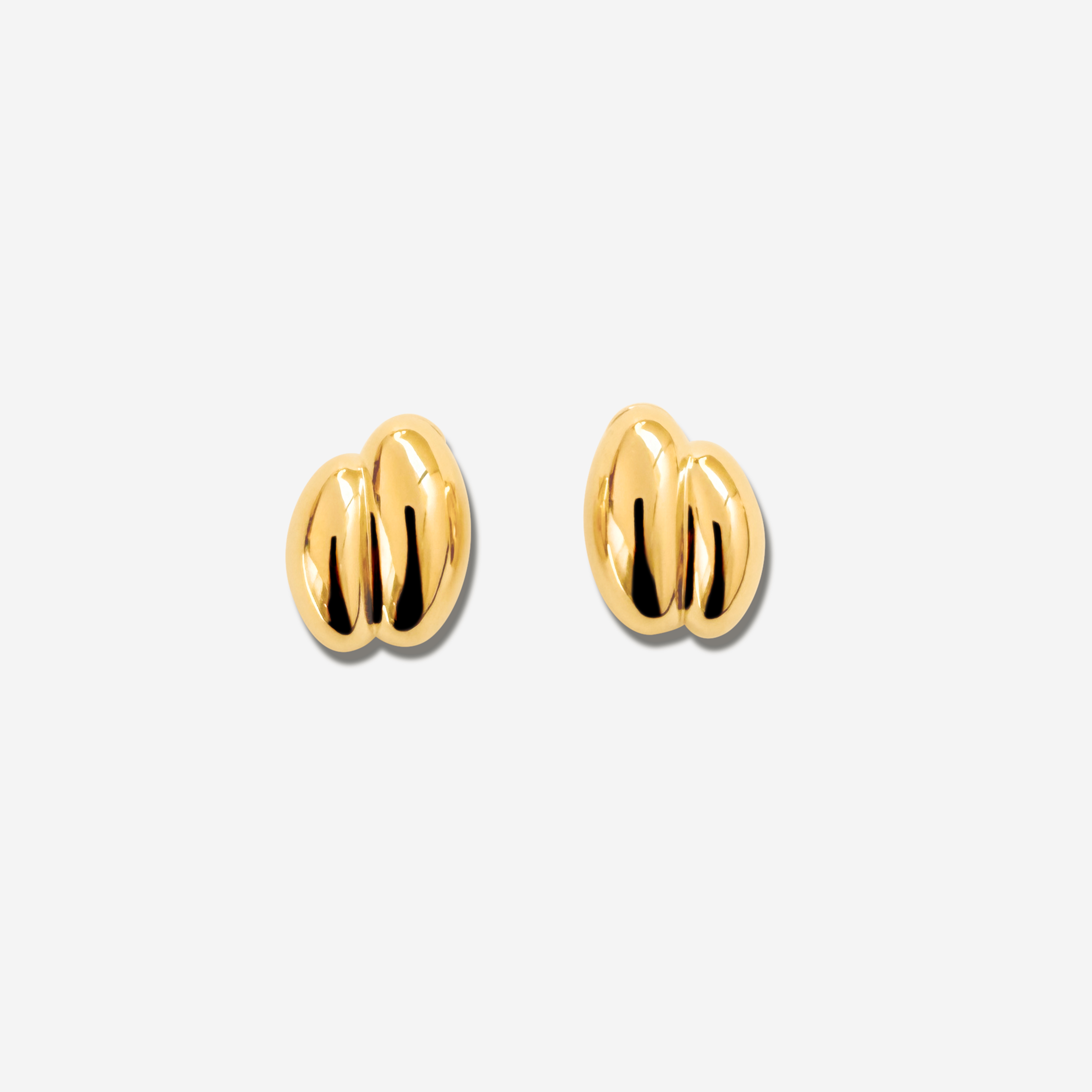 Discover the  Brioche Earrings by MÉGA Jewelry—oversized, sculptural hoops available in 14k gold or sterling silver vermeil. A bold statement piece for any jewelry collection.