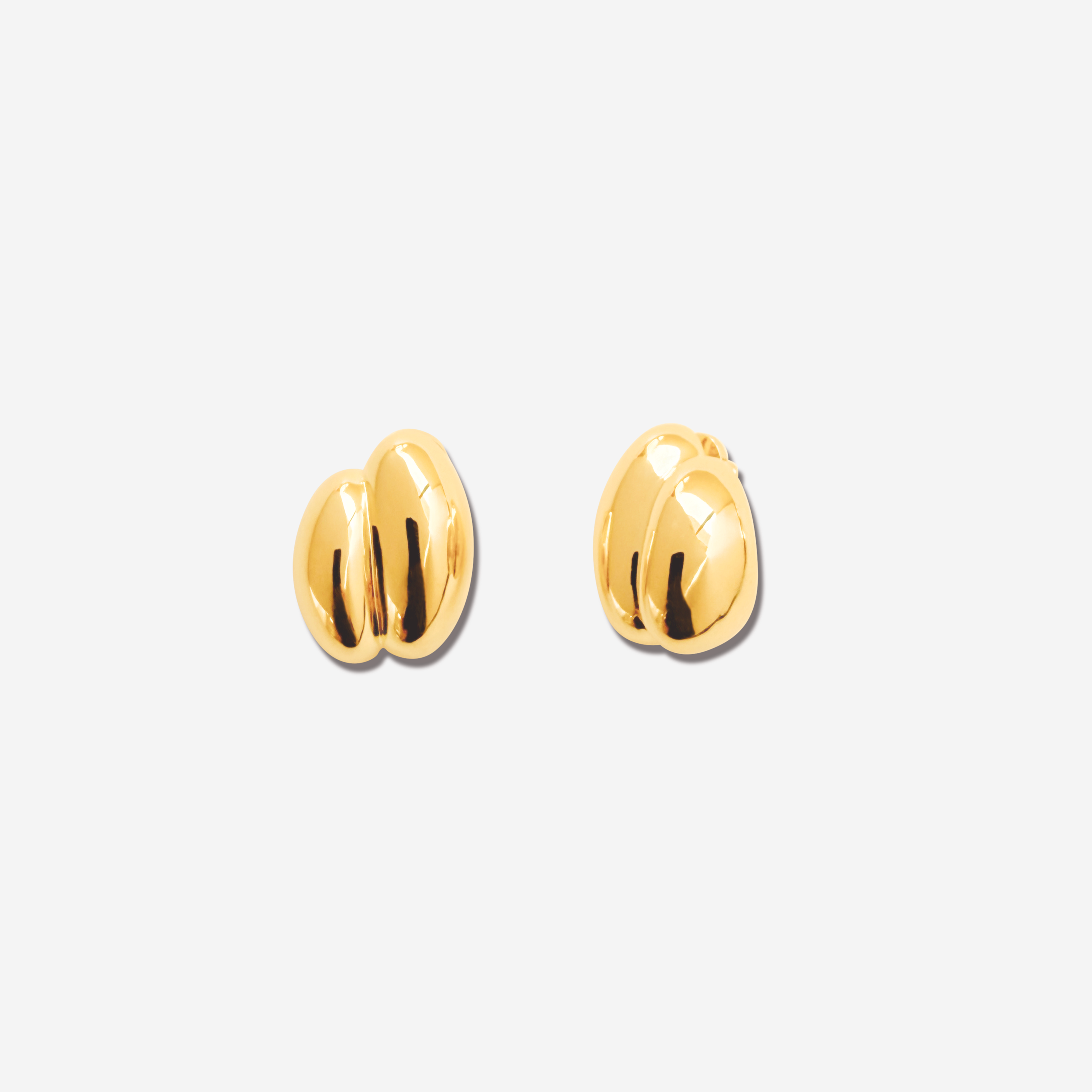 Discover the  Brioche Earrings by MÉGA Jewelry—oversized, sculptural hoops available in 14k gold or sterling silver vermeil. A bold statement piece for any jewelry collection.