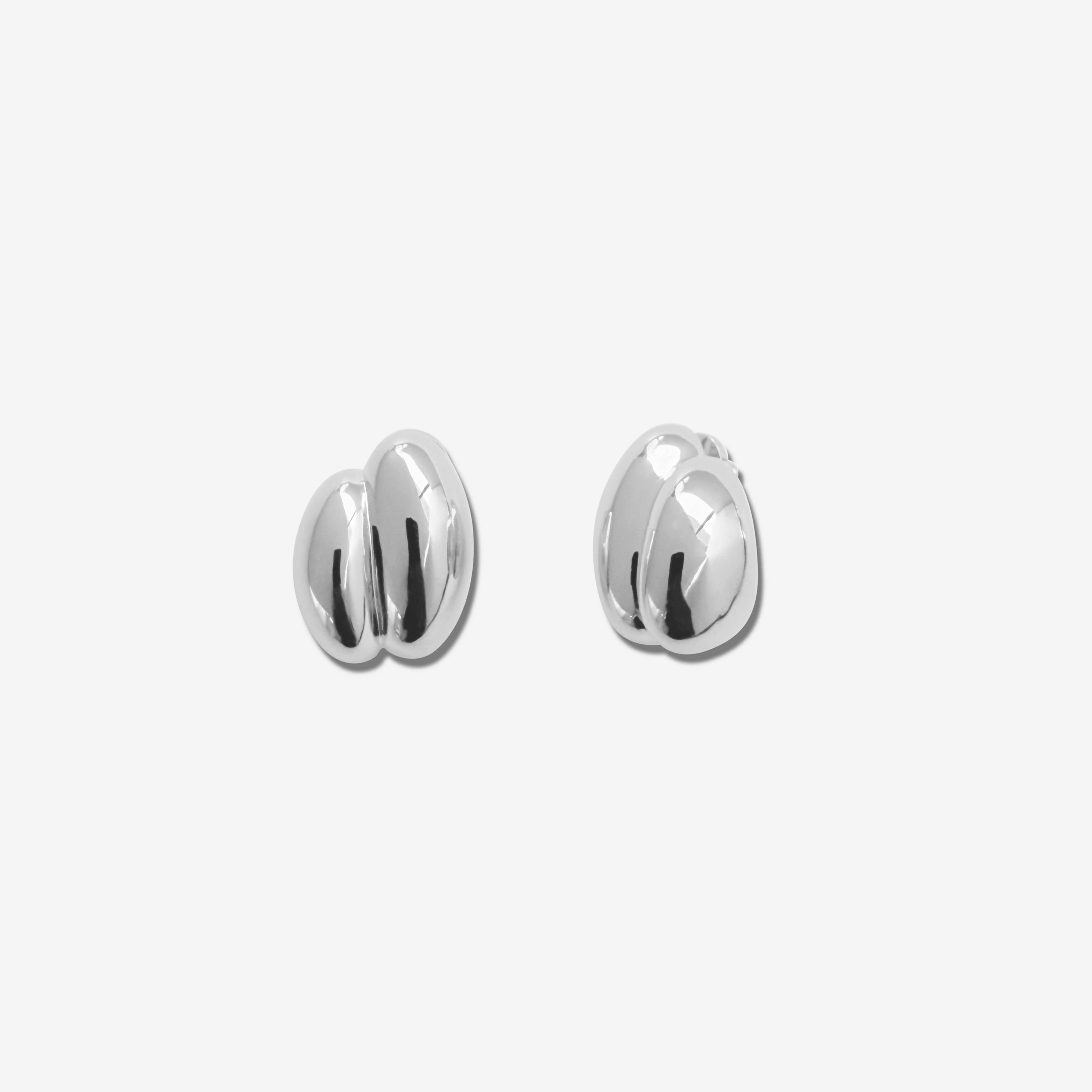 Discover the  Brioche Earrings by MÉGA Jewelry—oversized, sculptural hoops available in 14k gold or sterling silver vermeil. A bold statement piece for any jewelry collection.