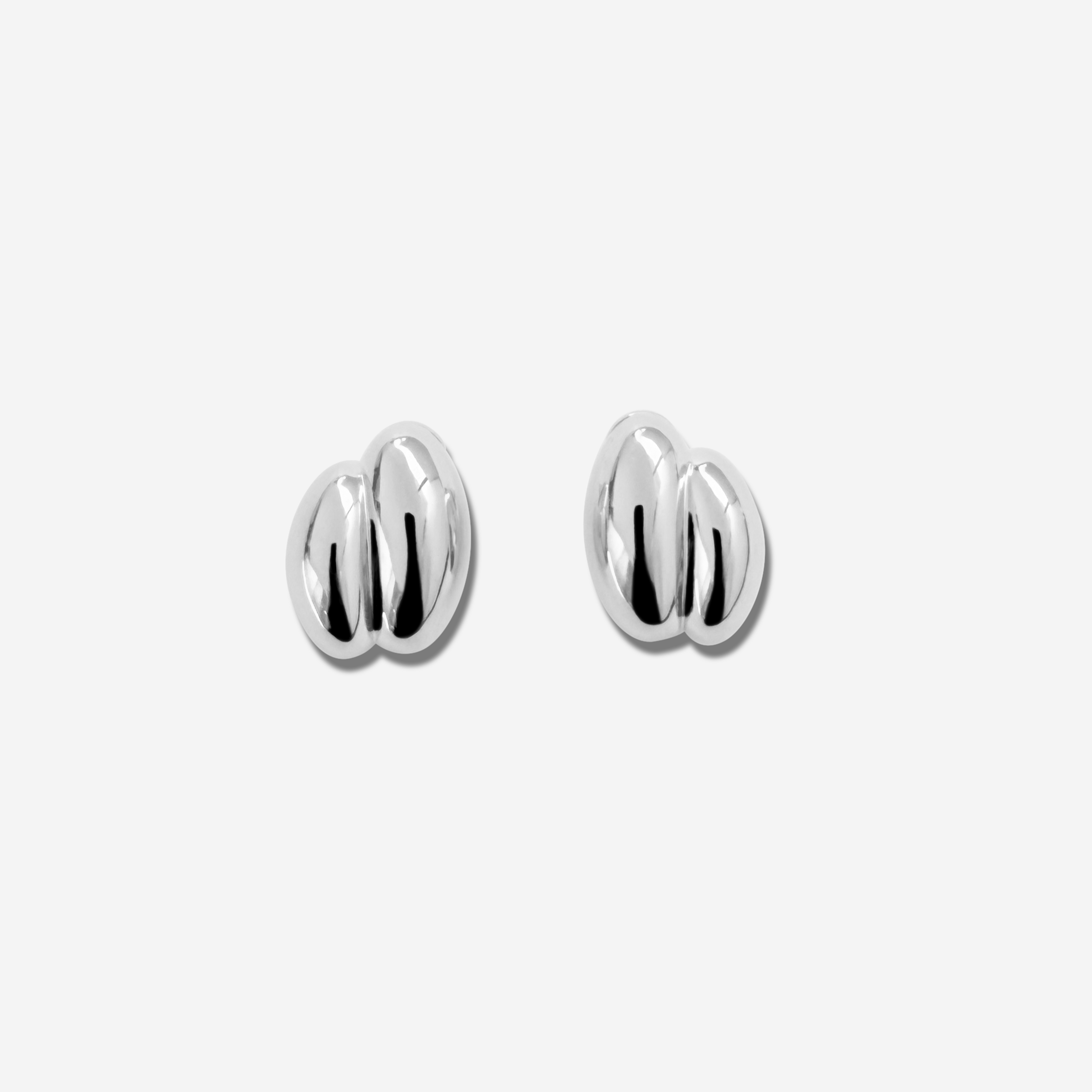 Discover the  Brioche Earrings by MÉGA Jewelry—oversized, sculptural hoops available in 14k gold or sterling silver vermeil. A bold statement piece for any jewelry collection.