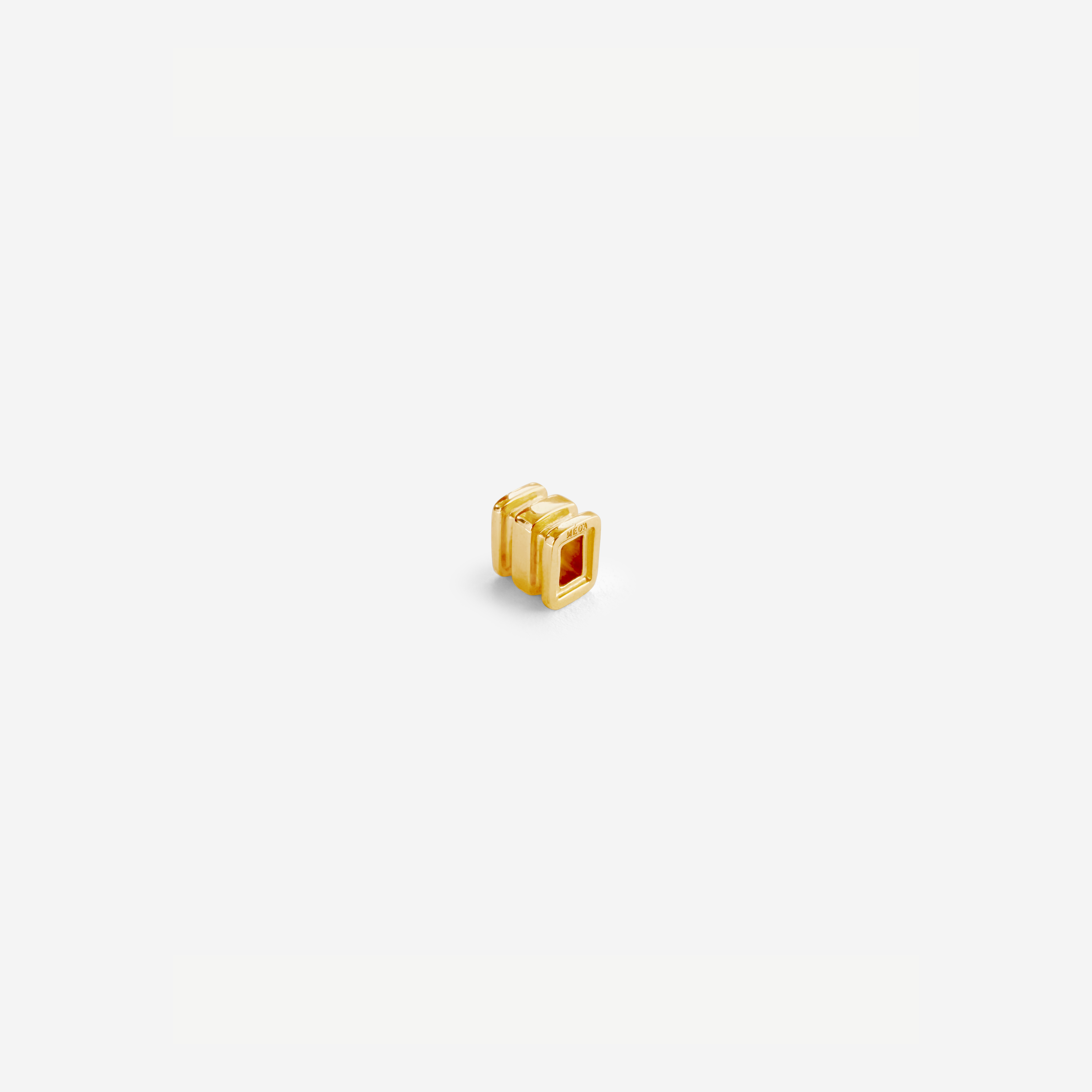 Small Omega Charm in gold, designed for the Omega 4 Necklace – delicate, polished, and stackable.