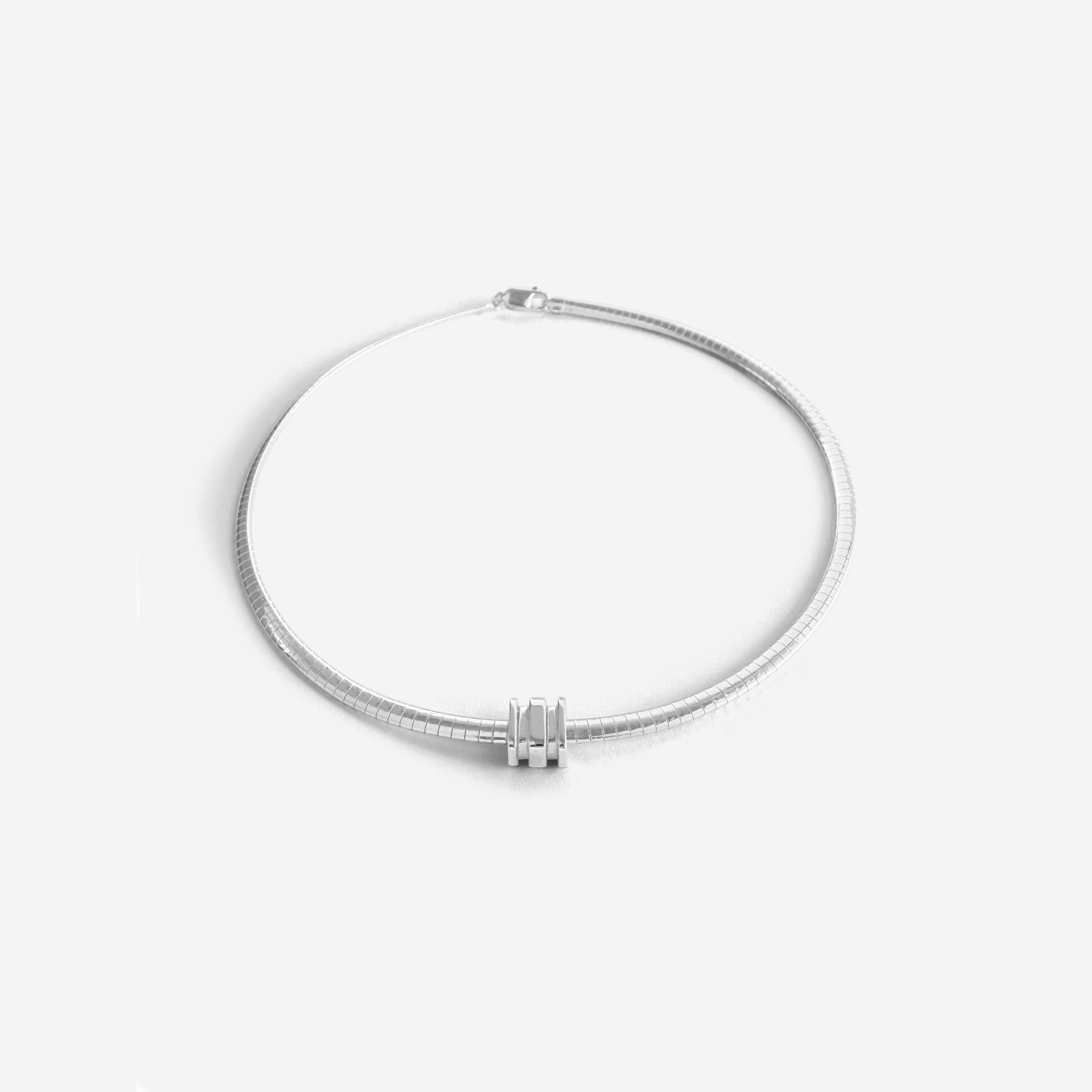 Small Omega Charm in gold, designed for the Omega 4 Necklace – delicate, polished, and stackable.