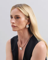 Featuring a sculptural pendant on an adjustable black leather cord, available in 14k gold or sterling silver vermeil.