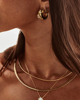 MÉGA Large Donut Earrings in gold vermeil—CZ-studded sculptural hoops, 26 × 10 mm, lightweight at 9 g, with stainless-steel posts.