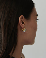 MÉGA Half Paper Clip Earrings in gold vermeil—16 mm long, 3.5 mm wide sculptural oval hoops with stainless-steel posts, 5.54 g.