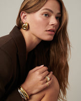 MÉGA Jumbo Double Knot Earrings in gold vermeil—lightweight oversized sculptural knot studs, 28 mm x 37 mm.