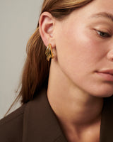 MÉGA Triple Time Earrings in gold vermeil—three graduated hoop earrings measuring 6.9 mm to 16.9 mm wide and 31.2 mm tall.