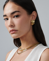 MÉGA Triple X Earrings in gold vermeil—29×19.9 mm overlapping “X” studs with stainless-steel posts, 10 g.
