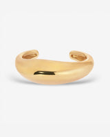 Lightweight brass Wave Cuff styled with minimalist jewelry