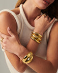 MÉGA Simone Cuff in gold vermeil—brass tapered cuff 42.5 mm to 14.3 mm wide, 11.7 mm tall, 51 g.
