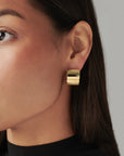 Chunky sculptural hoop earrings with a bold, rounded silhouette – lightweight and easy to wear daily.
